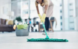 Shot of an unrecognisable woman mopping the floor at home